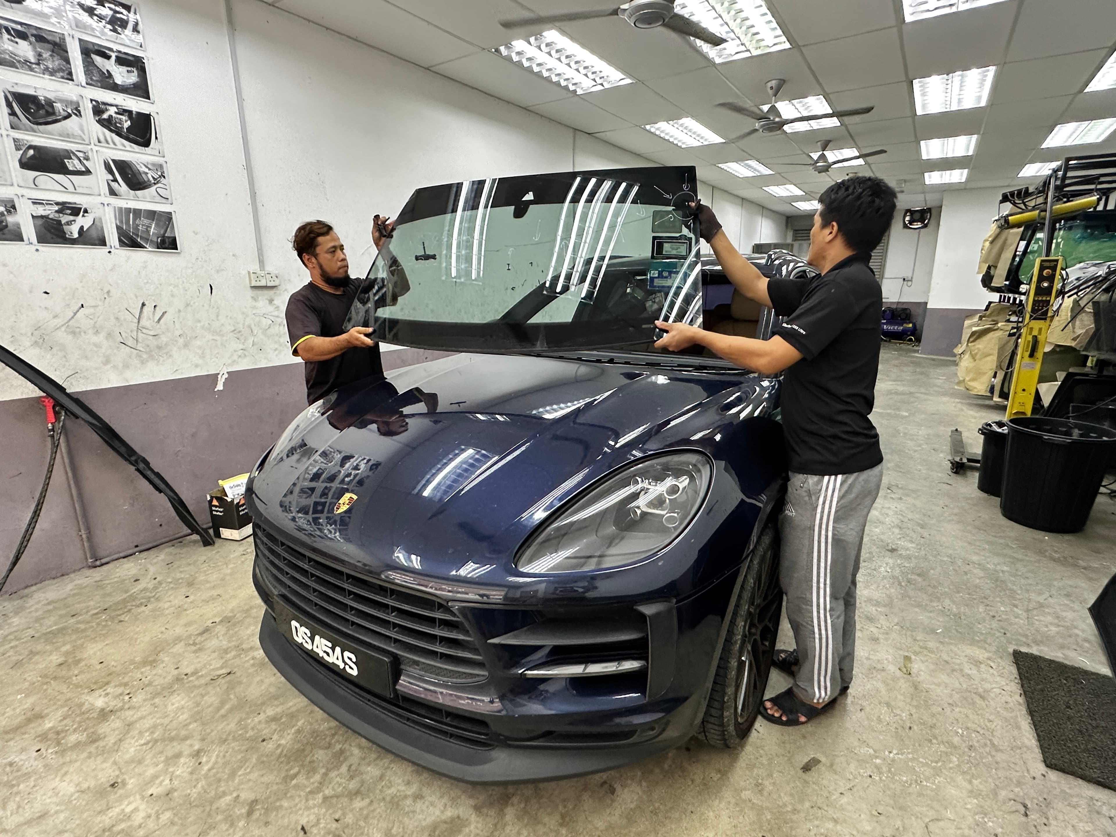 Technicians replacing a car windscreen at SIFU CERMIN Senawang HQ