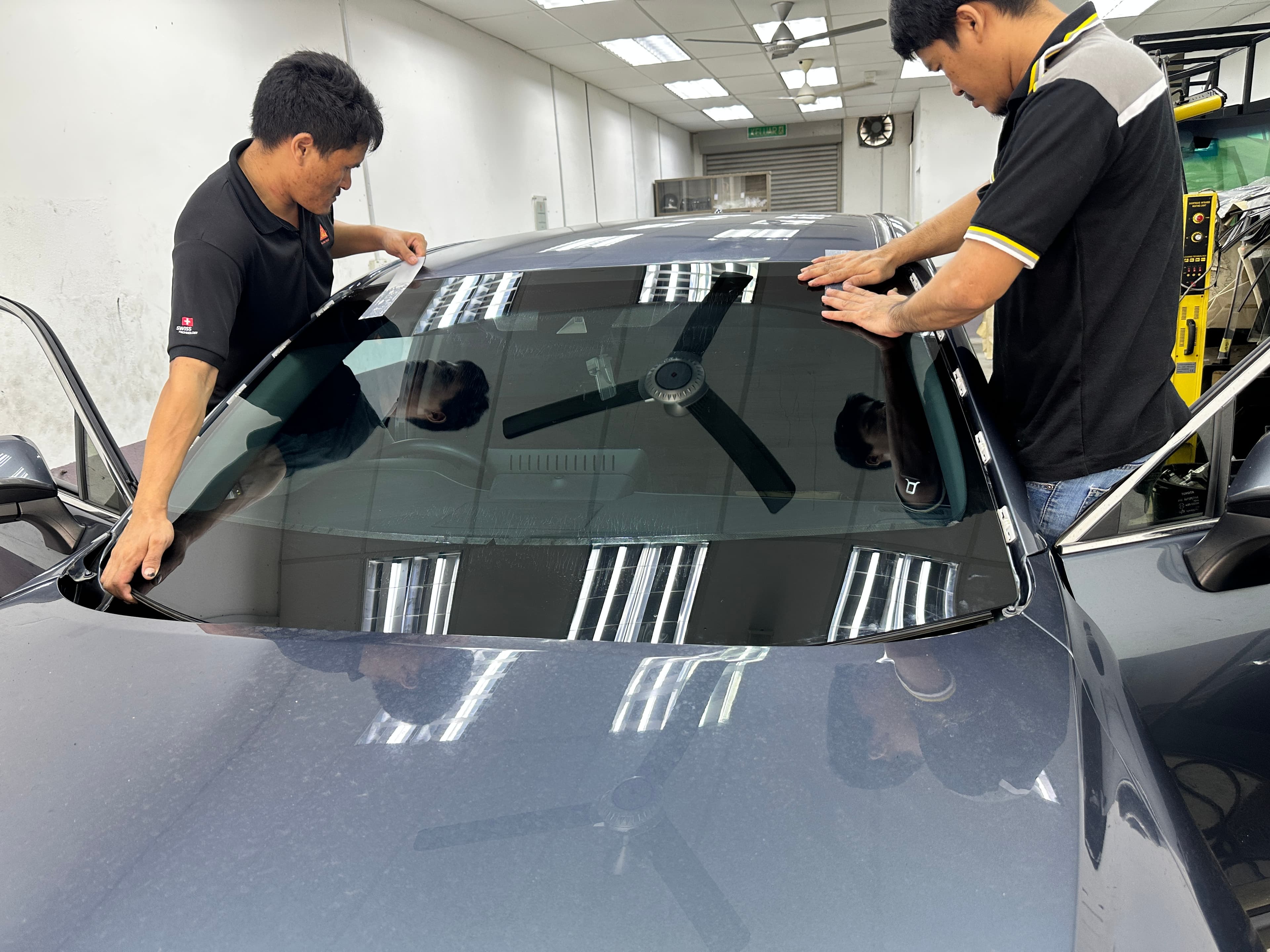 Technicians fitting a windscreen at SIFU CERMIN Senawang HQ